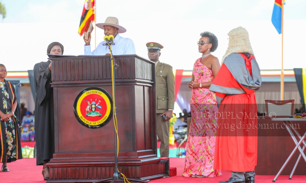 President Yoweri Kaguta Museveni lifts the Bible while taking the oath of office for his seventh term as President of Uganda during the swearing-in ceremony at Kololo Independence Grounds. Looking on are First Daughter Natasha Museveni Karugire (L) and Chief Justice Flavian Zeija. (PHOTO BY ALEX MASEREKA JOEL)