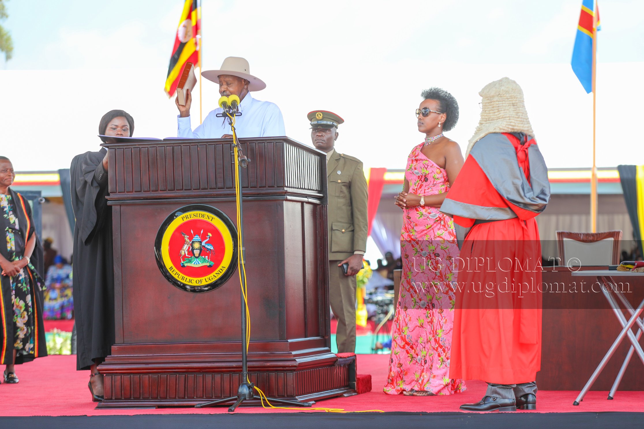 President Yoweri Kaguta Museveni lifts the Bible while taking the oath of office for his seventh term as President of Uganda during the swearing-in ceremony at Kololo Independence Grounds. Looking on are First Daughter Natasha Museveni Karugire (L) and Chief Justice Flavian Zeija. (PHOTO BY ALEX MASEREKA JOEL)