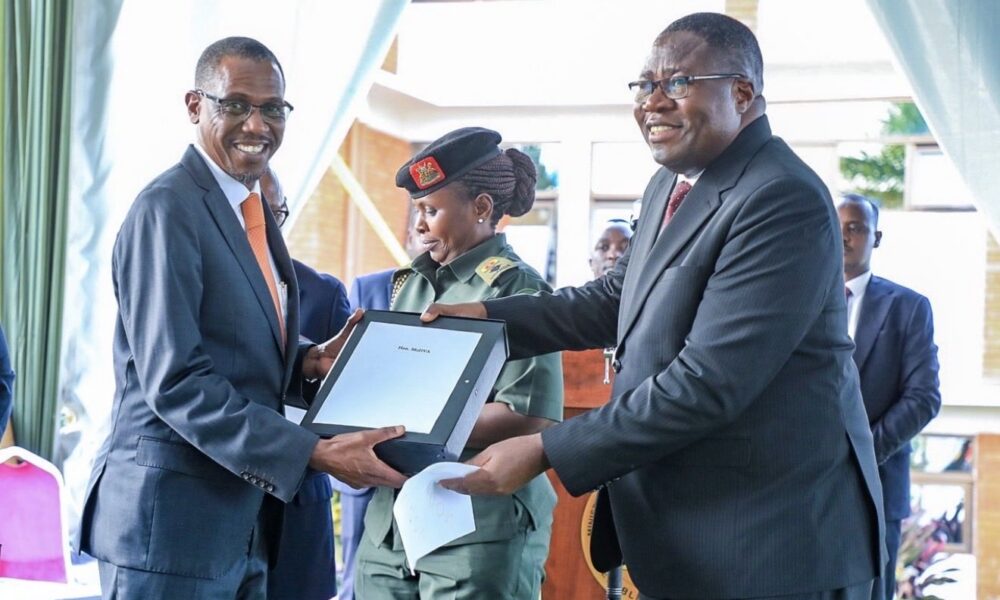 Speaker Jacobs Oboth-Oboth (R) hands over office to New Defence Minister Kiryowa Kiwanuka - UG DIPLOMAT