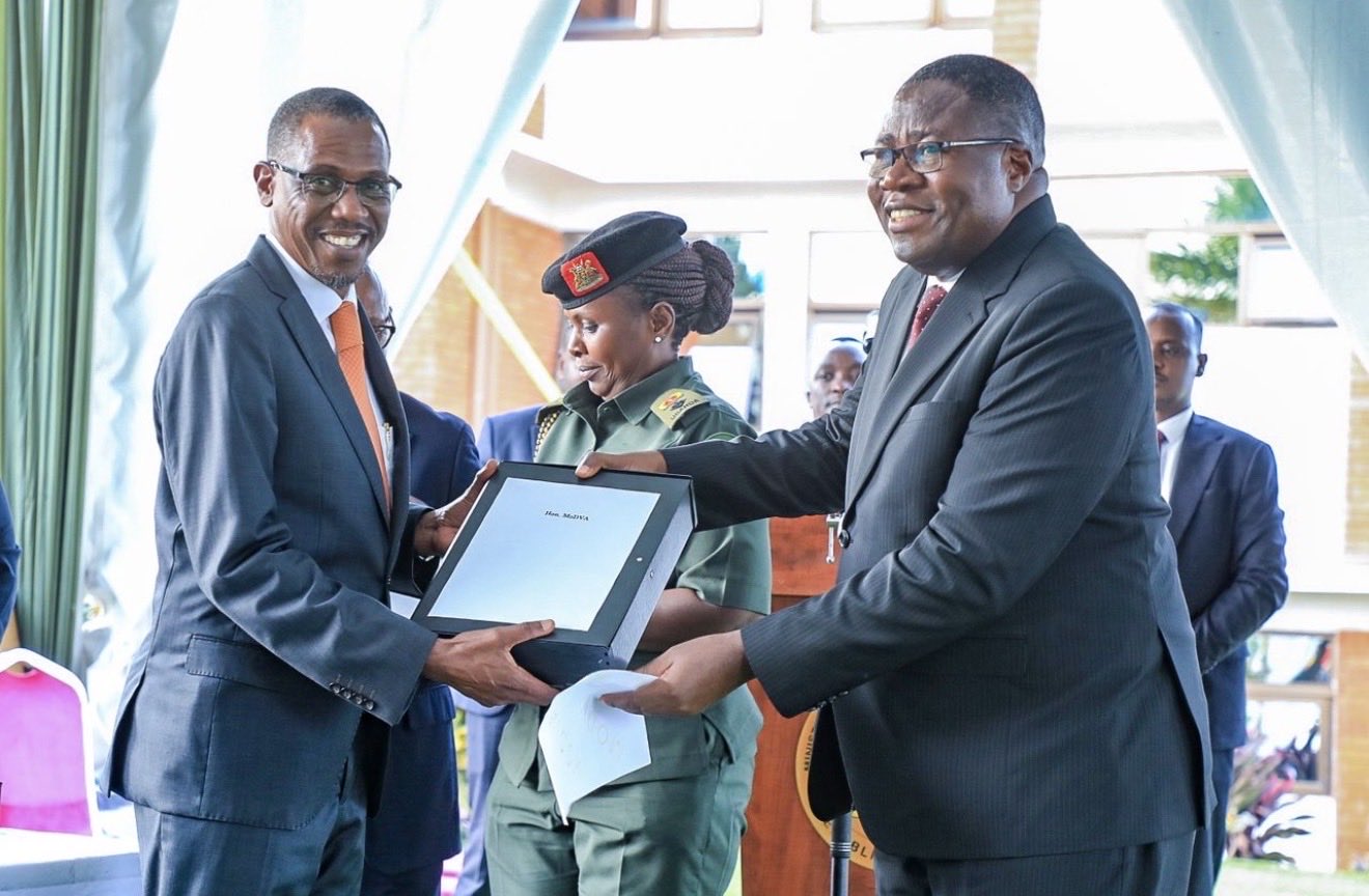 Speaker Jacobs Oboth-Oboth (R) hands over office to New Defence Minister Kiryowa Kiwanuka - UG DIPLOMAT